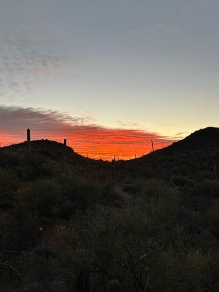Sunrise over the desert hills before the start