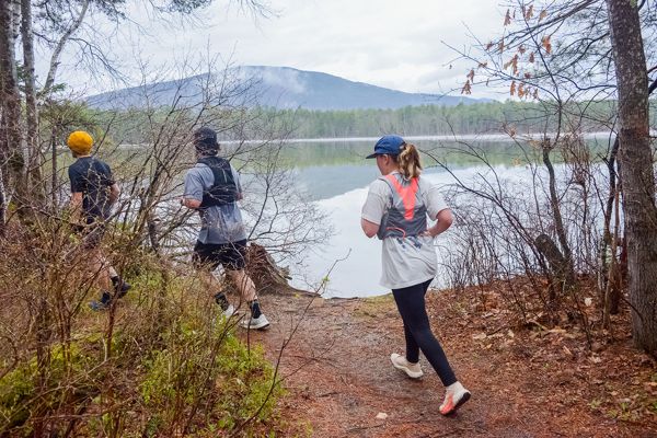 Runners passing the lake overlook on the loop