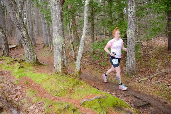 A runner on the mossy trail beside the bog