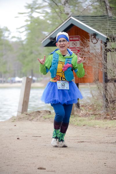 A runner in a blue tutu on the beach road