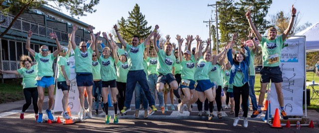 Runners jumping for joy at the start